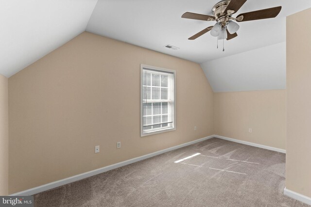 bonus room featuring ceiling fan, light carpet, and vaulted ceiling