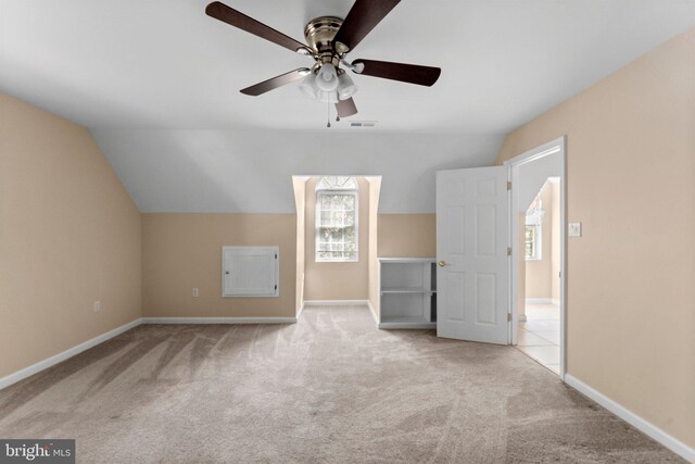 bonus room with ceiling fan, light colored carpet, and vaulted ceiling