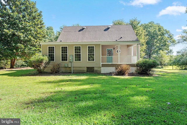 rear view of property with a yard and covered porch