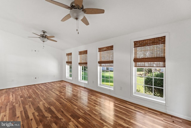 spare room with ceiling fan, hardwood / wood-style flooring, and a healthy amount of sunlight