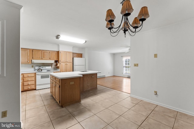 kitchen with ceiling fan with notable chandelier, white appliances, sink, light tile patterned flooring, and a kitchen island