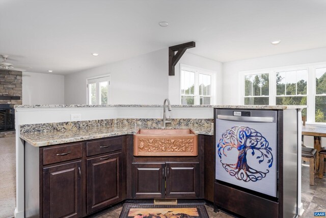 kitchen featuring plenty of natural light, sink, stainless steel dishwasher, and ceiling fan