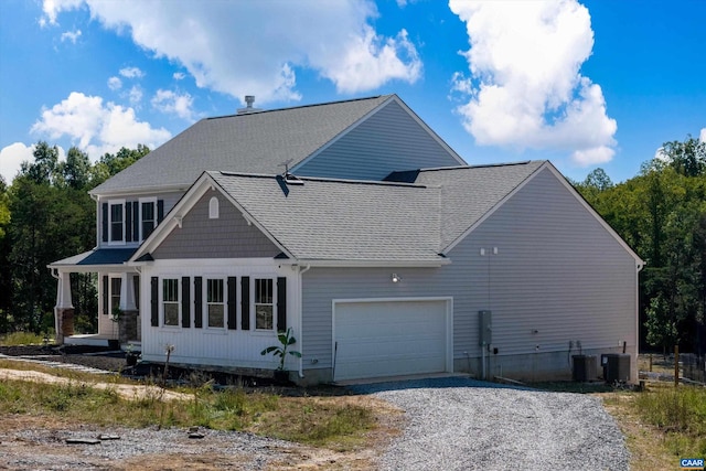 view of front facade with a garage and central air condition unit