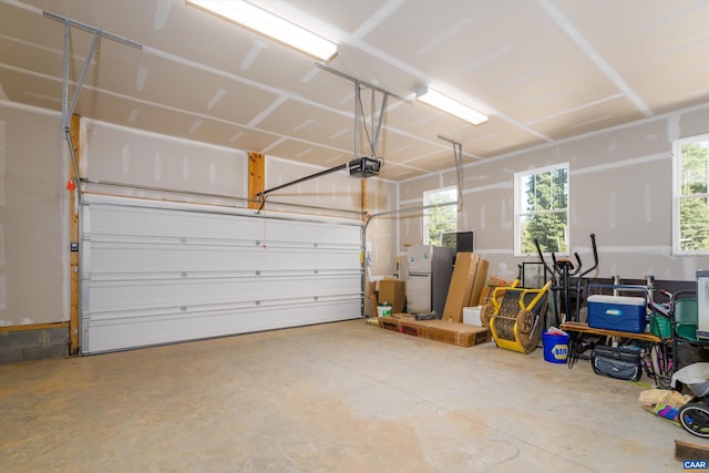 garage with a garage door opener and fridge