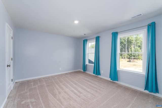 unfurnished room featuring light colored carpet