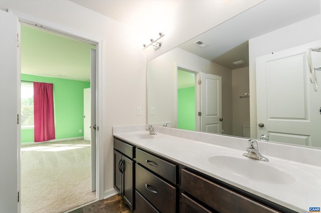 bathroom with toilet and vanity