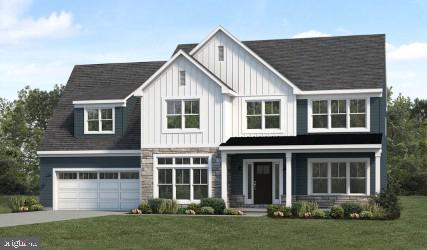 view of front of property with a garage and a front lawn