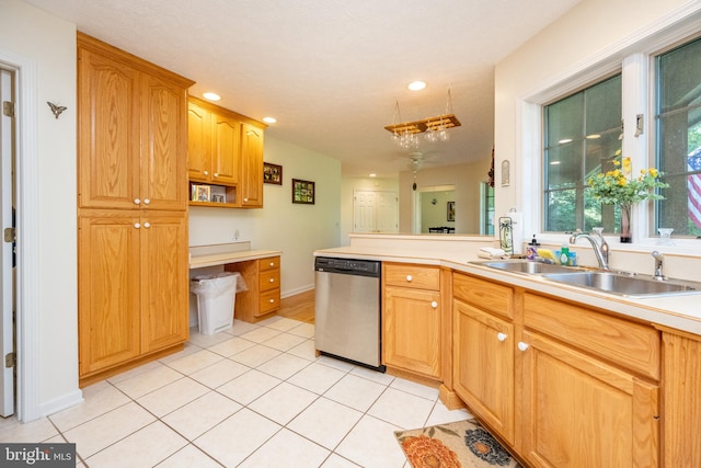 kitchen with dishwasher, light tile patterned floors, and sink