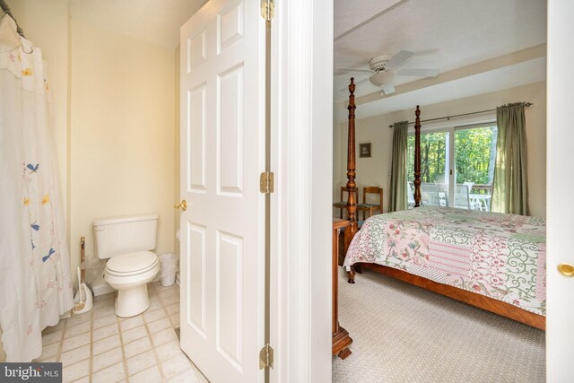 tiled bedroom featuring ceiling fan