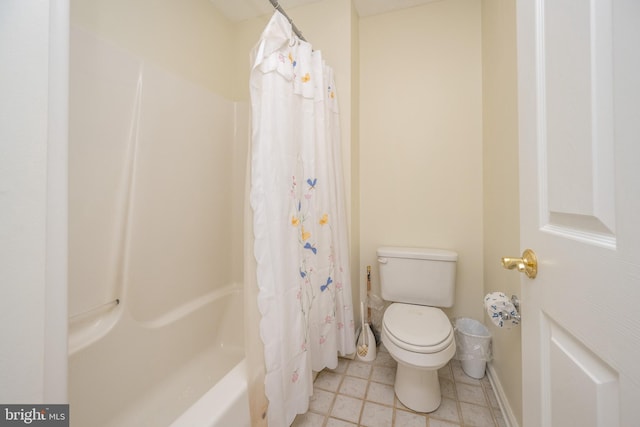 bathroom featuring tile patterned flooring, toilet, and shower / bath combination with curtain