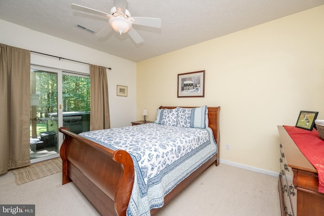 carpeted bedroom featuring a textured ceiling, access to outside, and ceiling fan