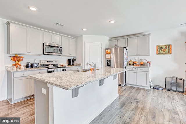 kitchen featuring light hardwood / wood-style flooring, sink, and appliances with stainless steel finishes