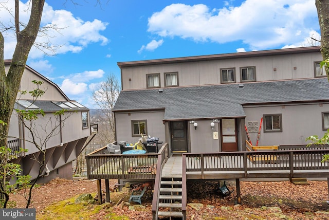 rear view of property with a wooden deck