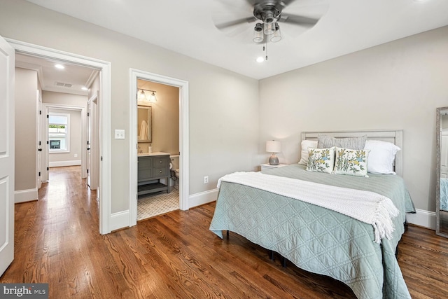 bedroom featuring ensuite bath, ceiling fan, and hardwood / wood-style flooring