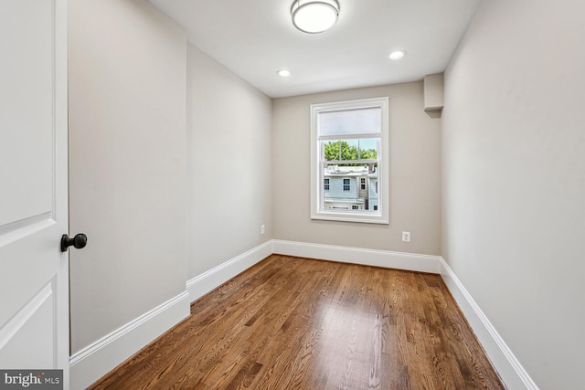 unfurnished room with wood-type flooring