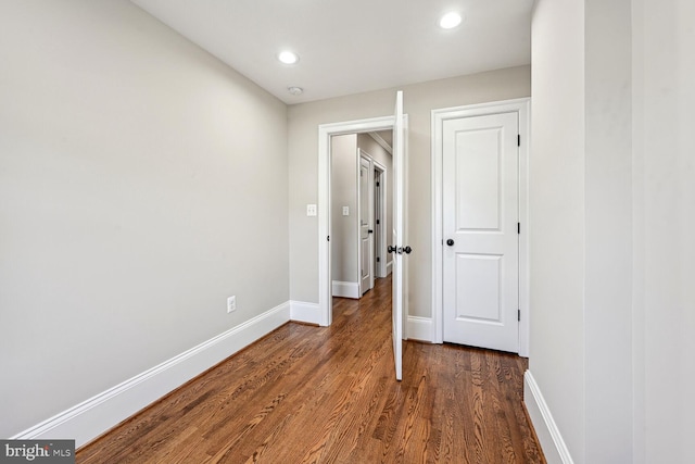 corridor with dark hardwood / wood-style floors