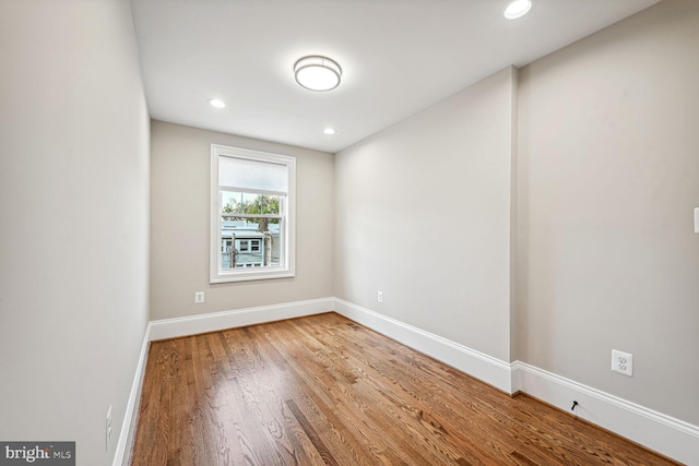 unfurnished room with hardwood / wood-style floors