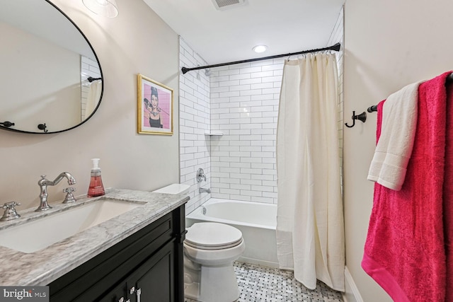 full bathroom with shower / bath combo, vanity, and toilet