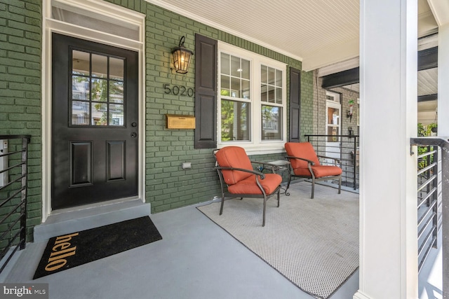 view of exterior entry with covered porch