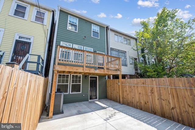 back of property with a patio area and central air condition unit