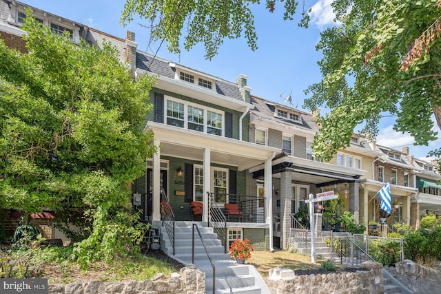 townhome / multi-family property featuring covered porch