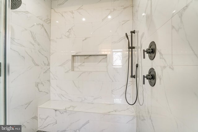 bathroom with tiled shower