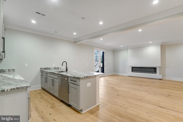 kitchen with gray cabinetry, sink, light hardwood / wood-style flooring, stainless steel dishwasher, and light stone counters