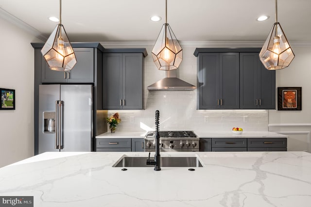 kitchen with light stone countertops, appliances with stainless steel finishes, hanging light fixtures, and crown molding