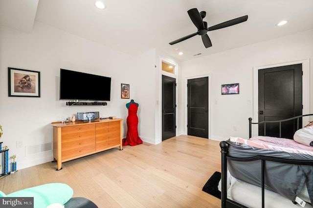 bedroom with ceiling fan and hardwood / wood-style flooring