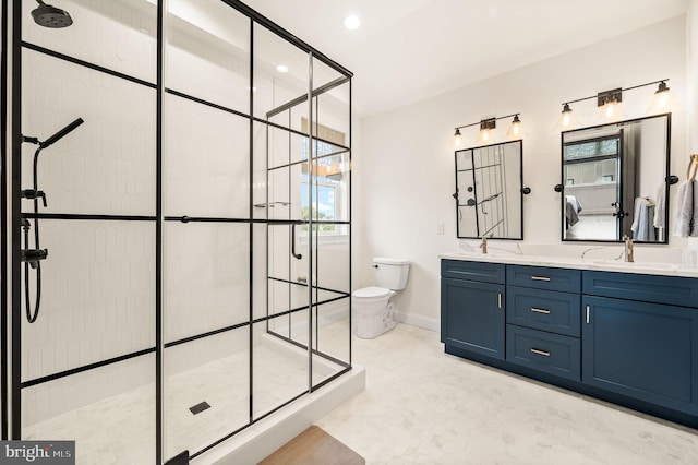 bathroom with a shower with shower door, vanity, and toilet