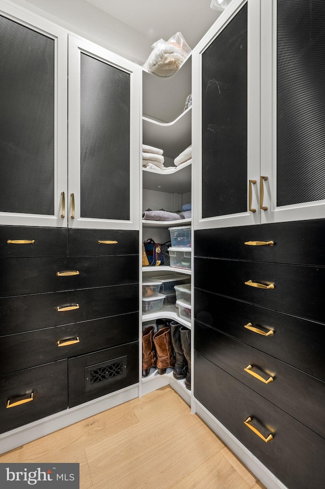 walk in closet featuring hardwood / wood-style floors