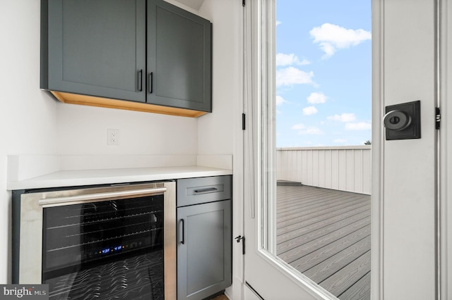 bar featuring gray cabinetry and beverage cooler