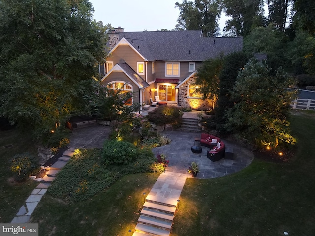 view of front facade featuring a patio and a front lawn