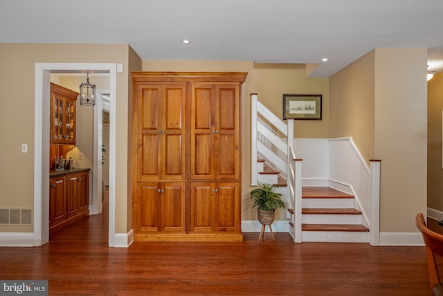 interior space with a chandelier and dark hardwood / wood-style floors