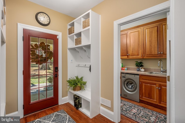 mudroom with washer / dryer, sink, and dark hardwood / wood-style flooring