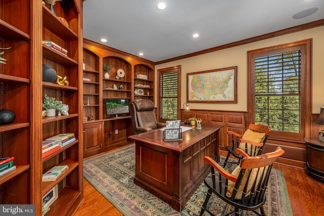 office with hardwood / wood-style floors and crown molding