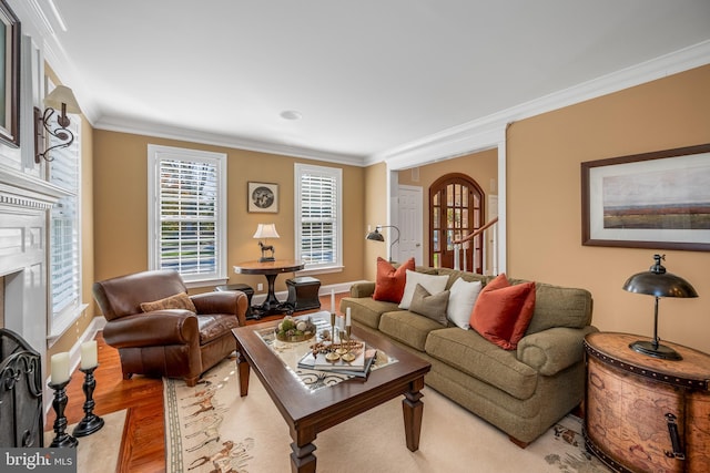 living room with light hardwood / wood-style floors and crown molding