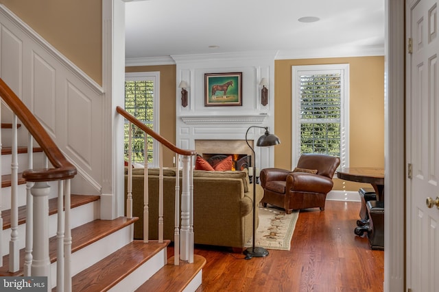 interior space with ornamental molding and hardwood / wood-style floors