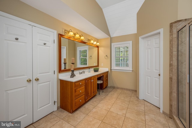 bathroom with vanity, an enclosed shower, vaulted ceiling, and tile patterned floors