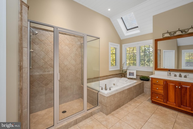 bathroom with vanity, plus walk in shower, lofted ceiling with skylight, and tile patterned flooring