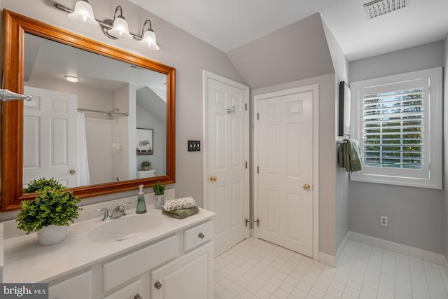 bathroom with vanity, tile patterned floors, vaulted ceiling, and a shower with shower curtain