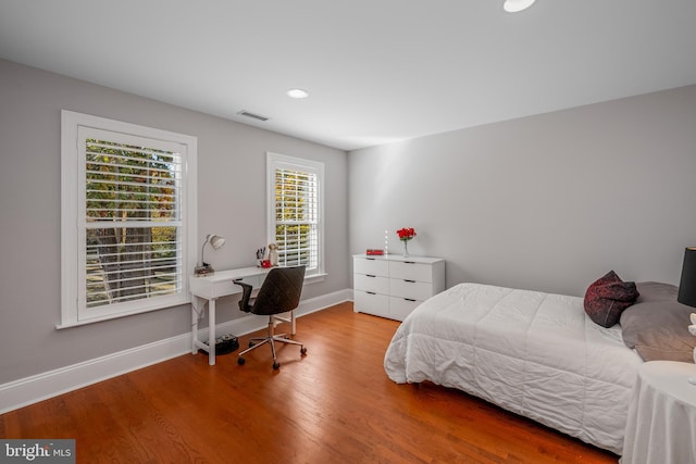 bedroom with hardwood / wood-style flooring