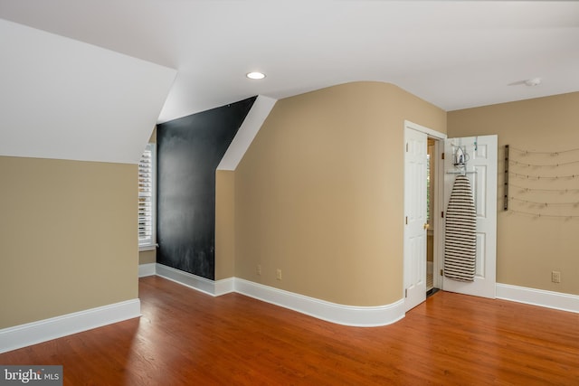 bonus room featuring wood-type flooring and vaulted ceiling