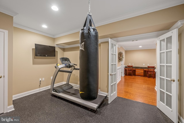 exercise area featuring crown molding, french doors, and dark hardwood / wood-style flooring