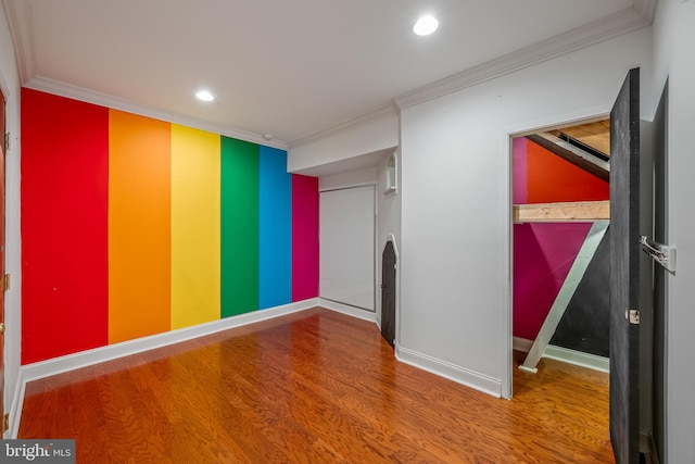 spare room featuring crown molding and hardwood / wood-style flooring