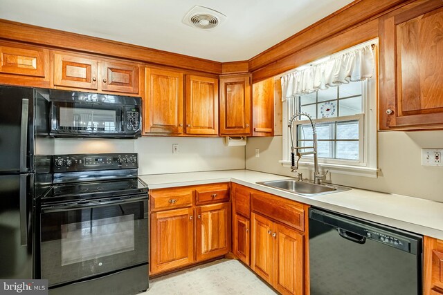 kitchen featuring black appliances and sink