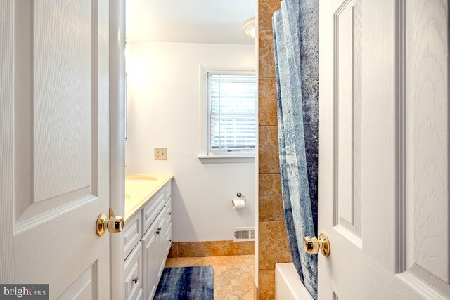 bathroom with tile patterned floors, shower / tub combo, and vanity