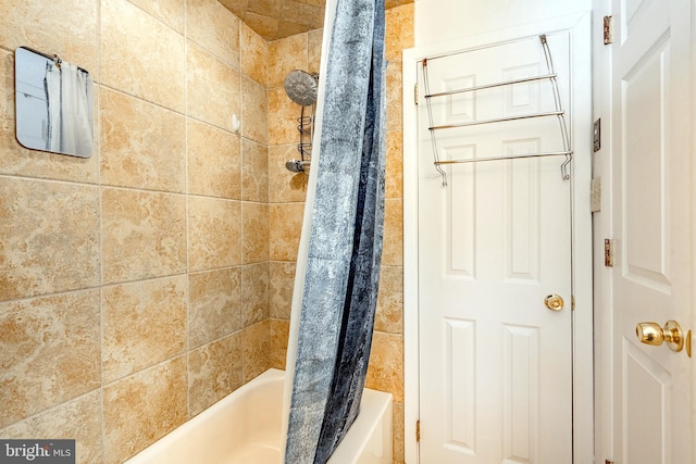 bathroom with shower / bath combination with curtain