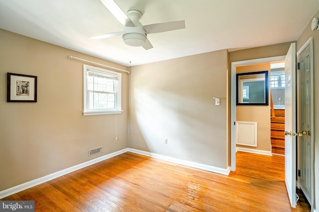 spare room featuring ceiling fan and light wood-type flooring