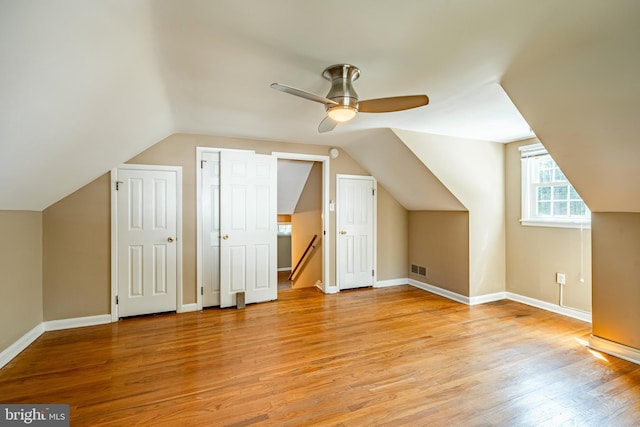 bonus room featuring light wood-type flooring, ceiling fan, and lofted ceiling